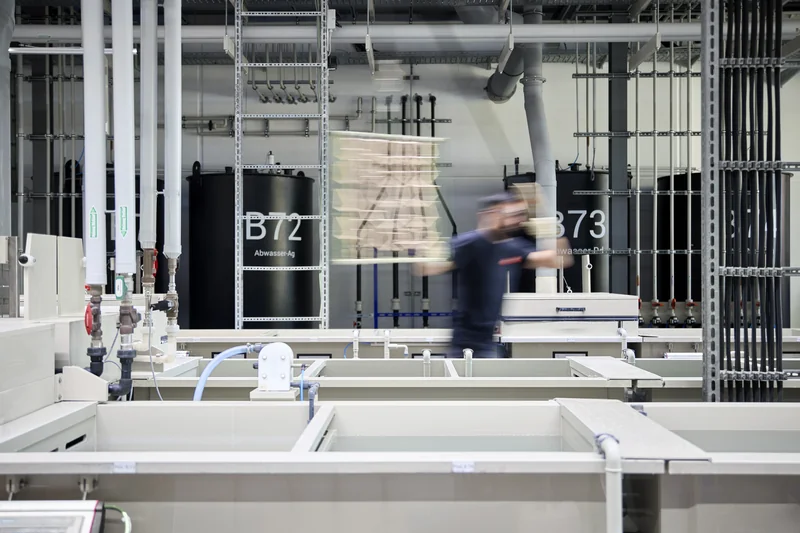 Mitarbeiter transportiert ein Gestell durch die Gestellgalvanik-Produktion bei der C. Jentner GmbH